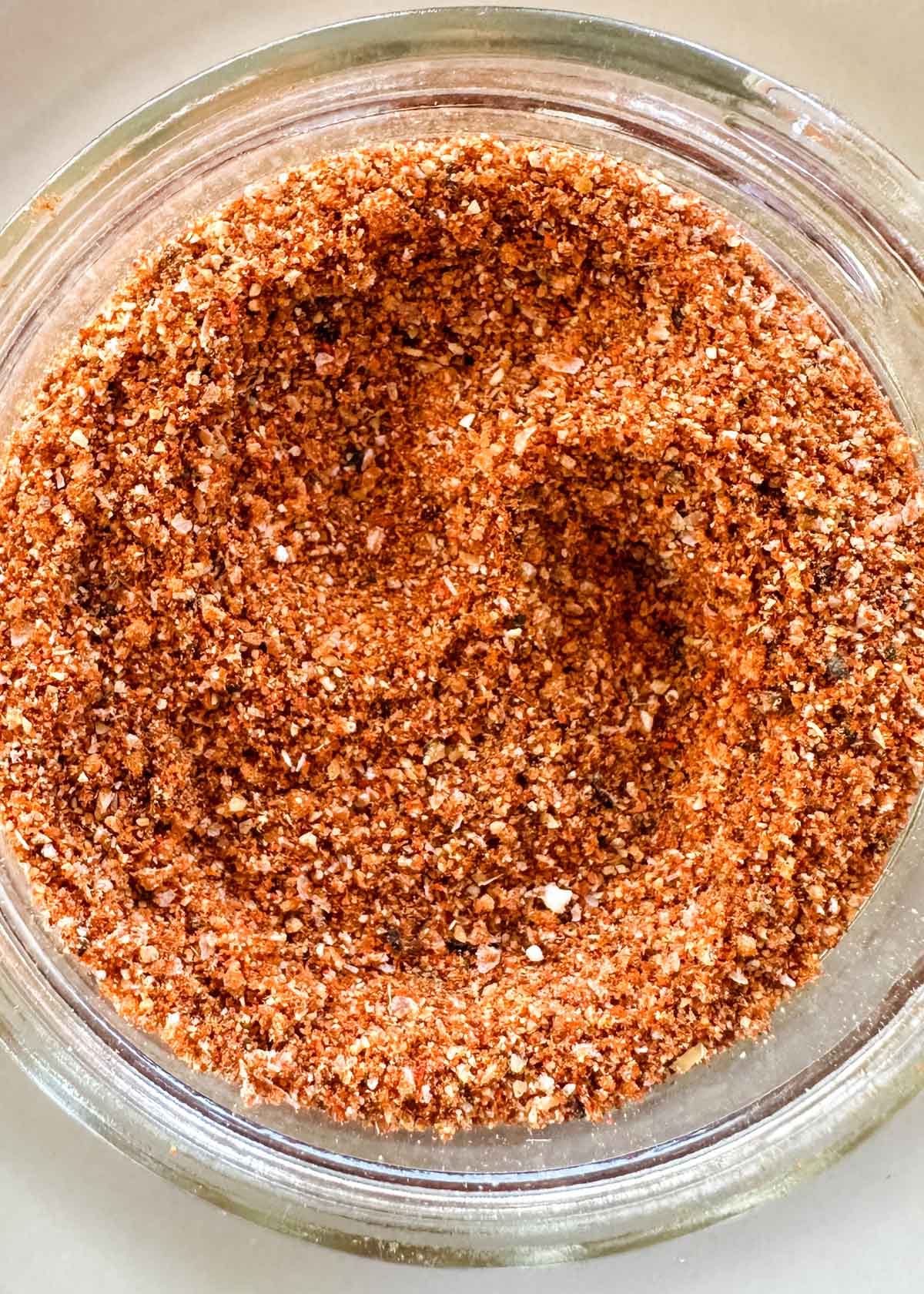 closeup of mixed burger seasoning in a glass mason jar