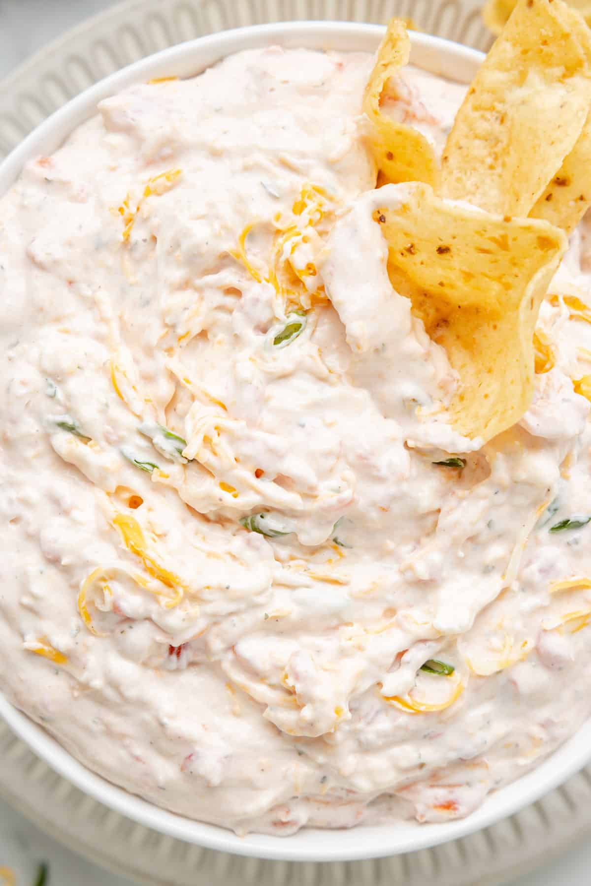 closeup overhead of Boat Dip in a bowl with scoops tortilla chips