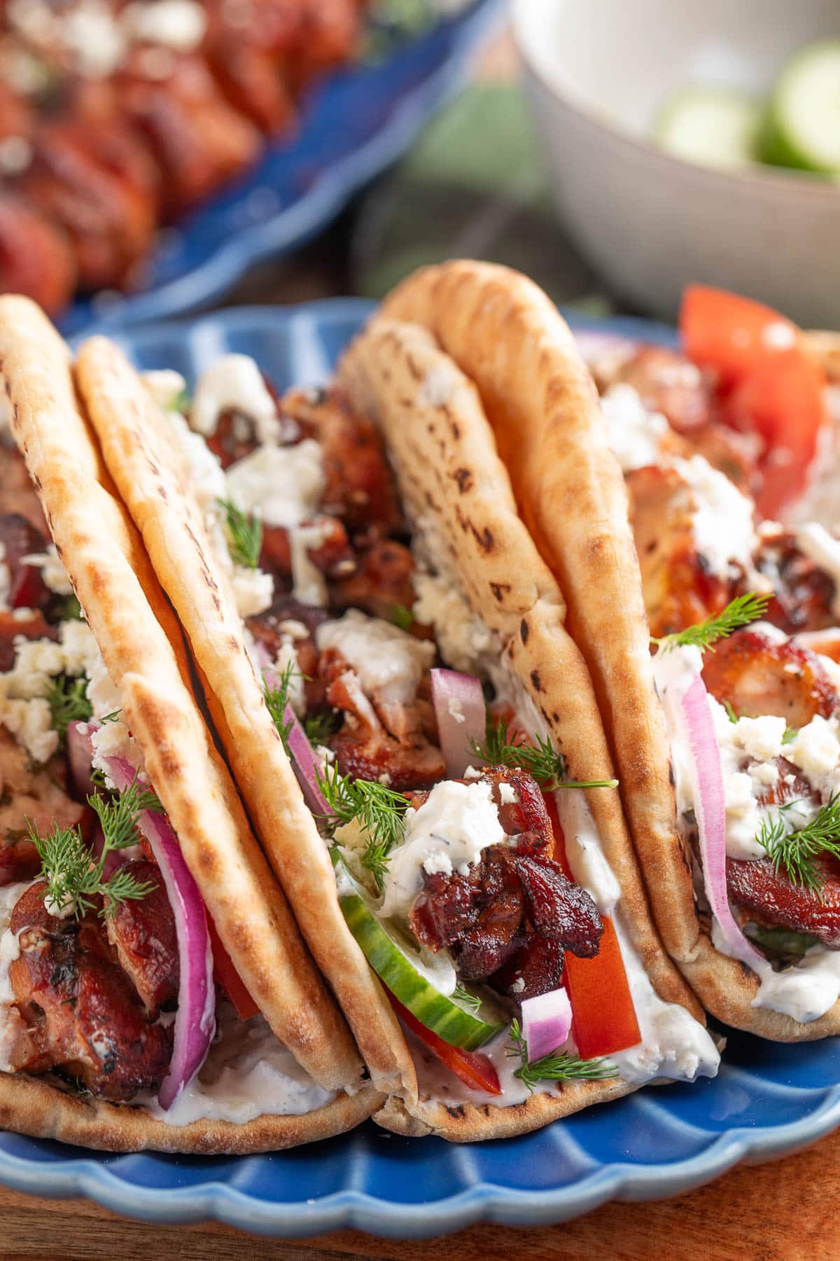 smoked chicken souvlaki in pita bread with feta, cucumbers, tomatoes, red onions, and tzatziki sauce