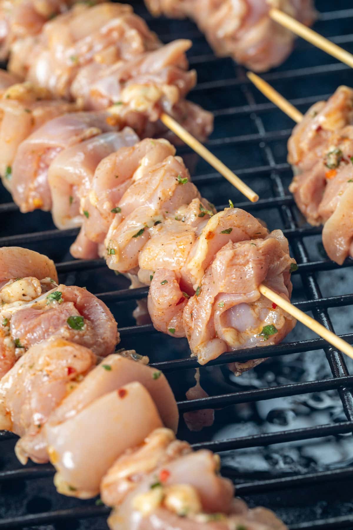 raw chicken souvlaki skewers on a pellet gril