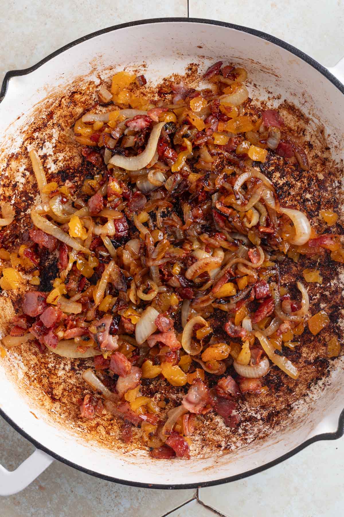 bacon, apricot, and onion topping for cream cheese in a white skillet