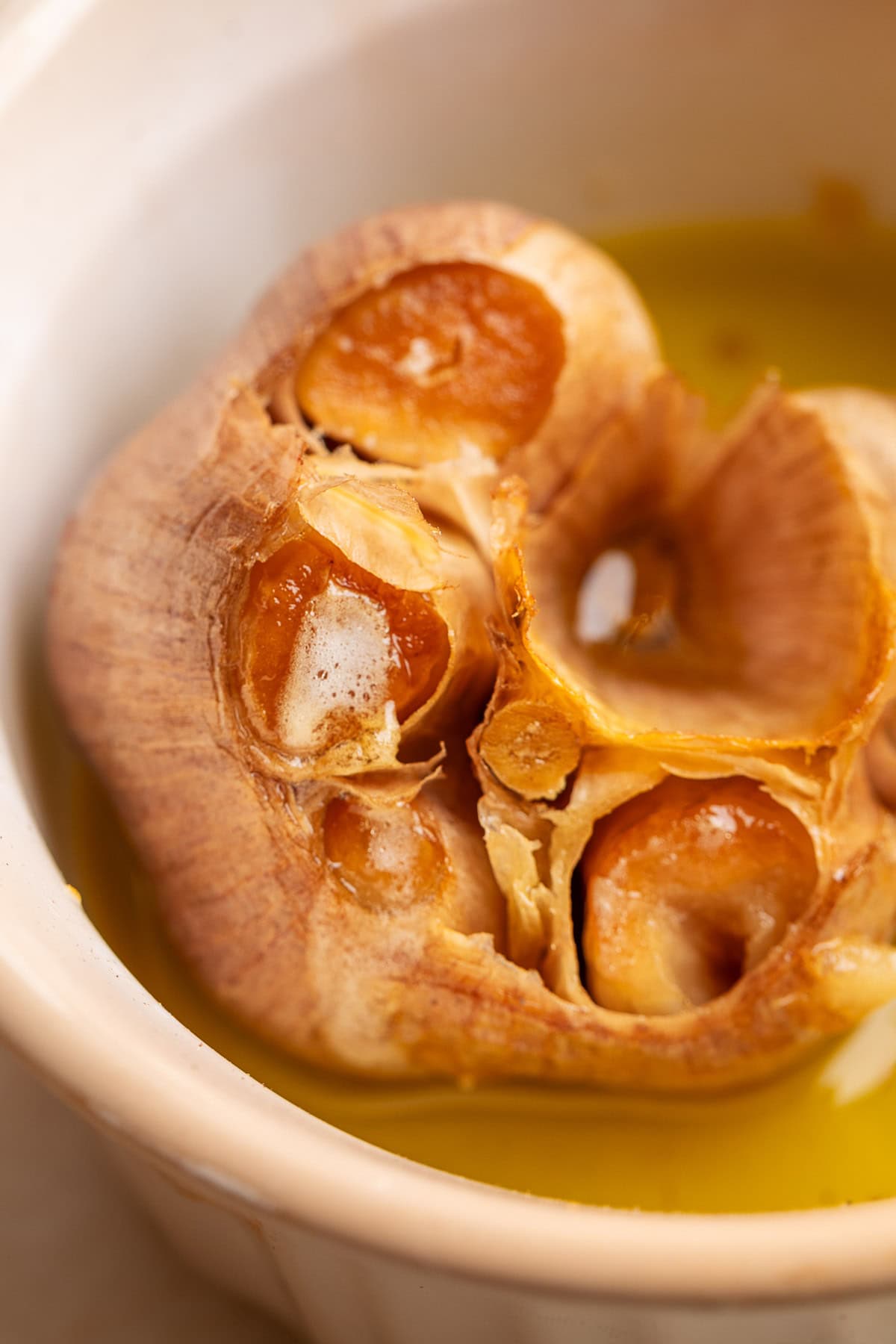 smoked garlic in a white ramekin with olive oil